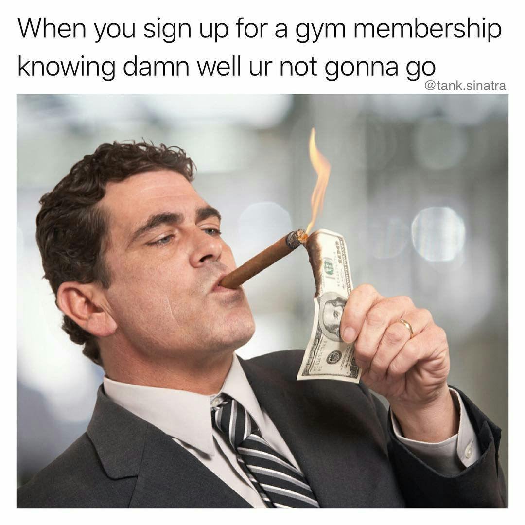Image of man using burning money to light a cigar