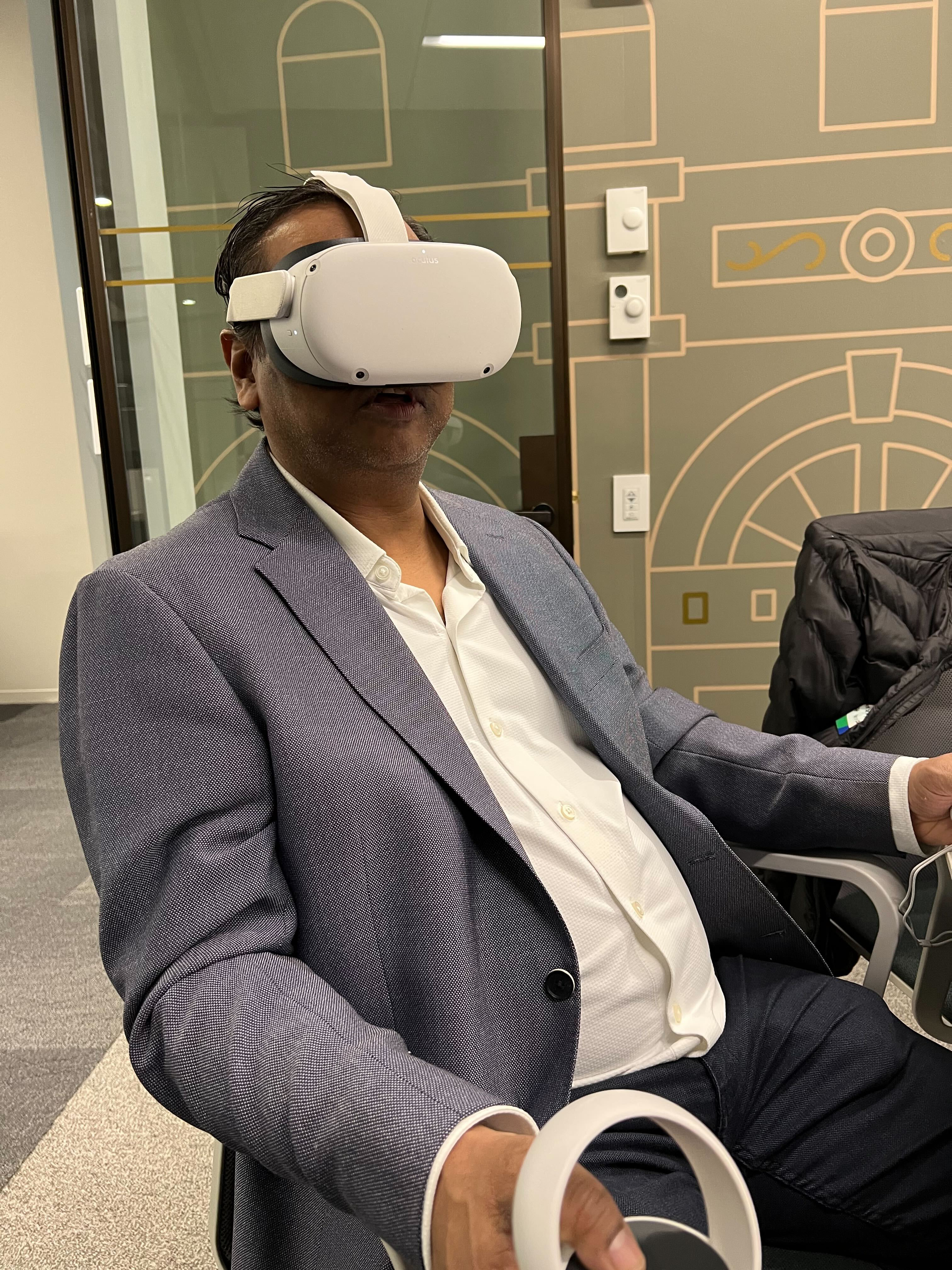 A person wearing a VR headset sitting down